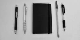 Pocket Notebook between pens and pencils